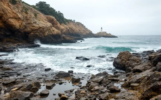 A rocky coastline with a distant lighthouse